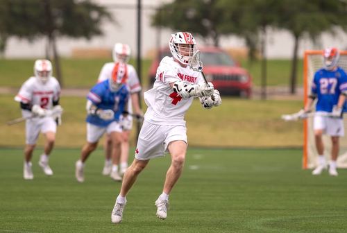 Ezrah playing lacrosse in a Simon Fraser jersey